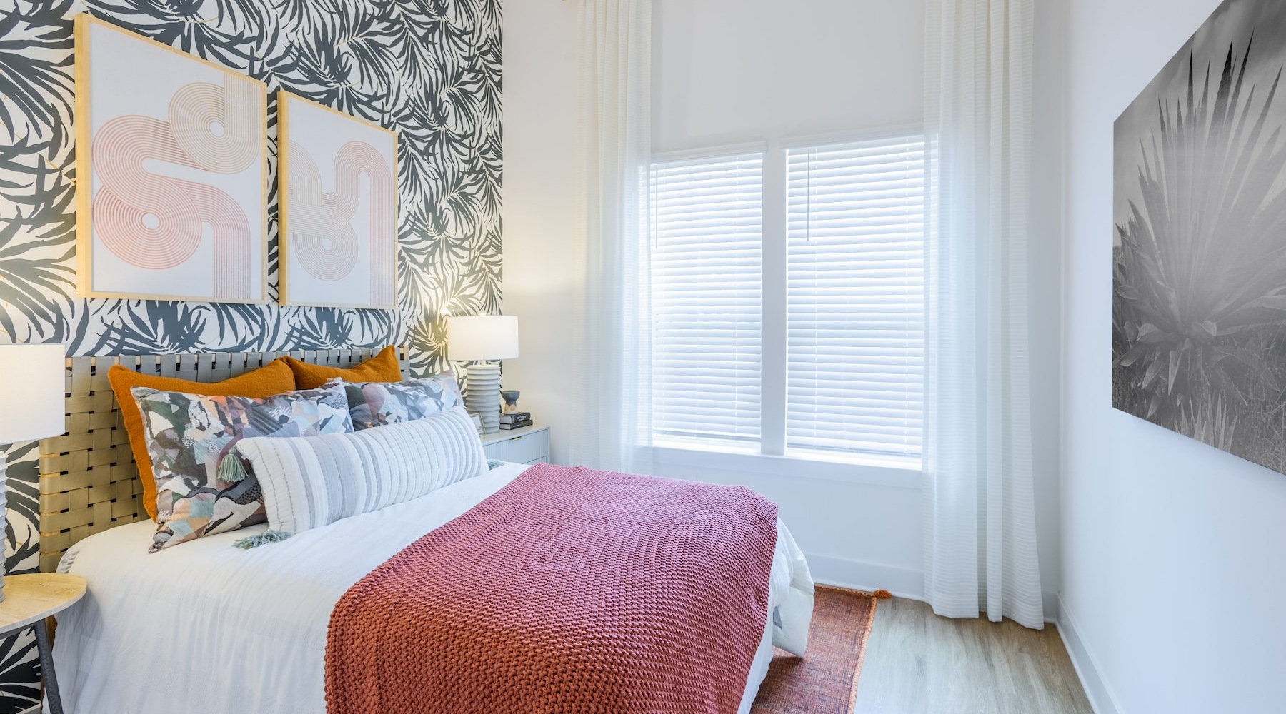 Furnished bedroom with a large window at Artizia at Loso apartments for rent in Charlotte, NC