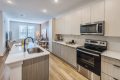 Brand New Apartments in Charlotte, NC - The Artizia at Loso - Kitchen with Stainless-Steel Appliances, Sleek Cabinetry, and Quartz Countertops